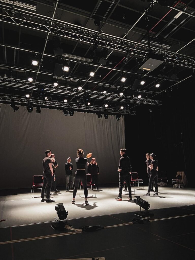 Performers rehearsing on a theatre stage